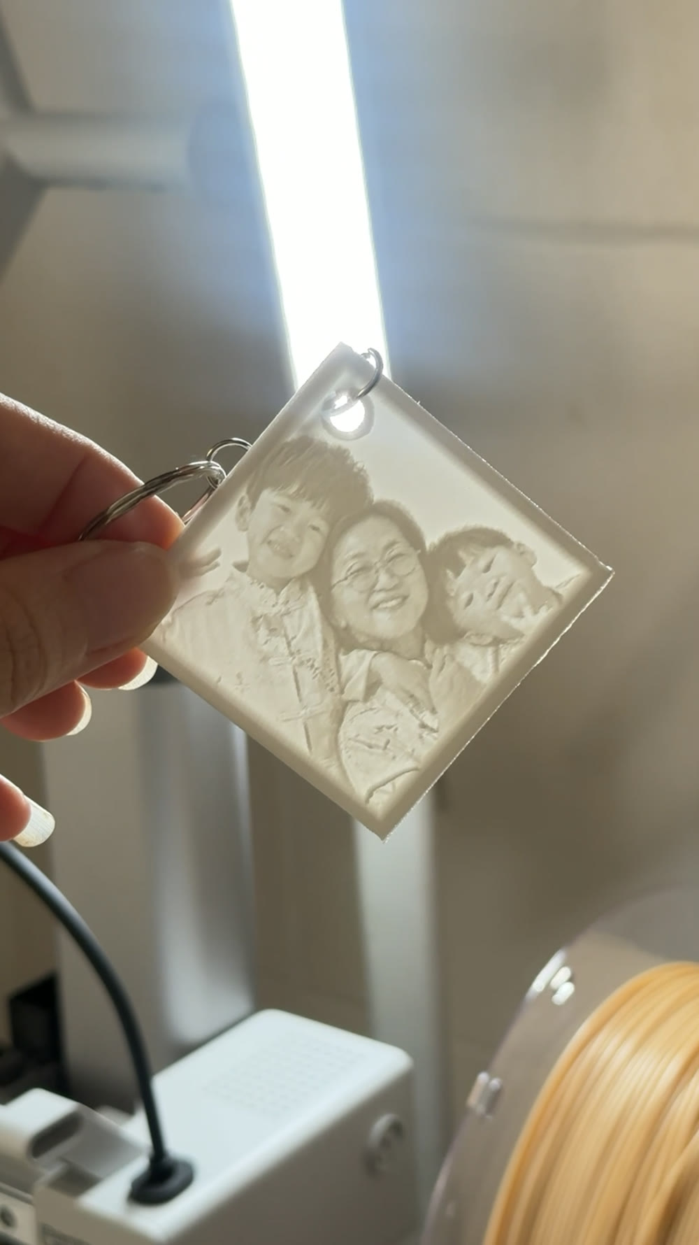 Photo Reveal Keychain held to light with the hidden image revealed